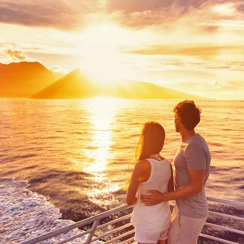 Couple enjoying a sunset on a cruise ship deck