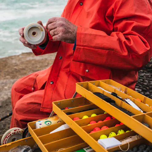 close-up-fisherman-putting-bait-with-fishing-equipment-box-fishing-sport-concept